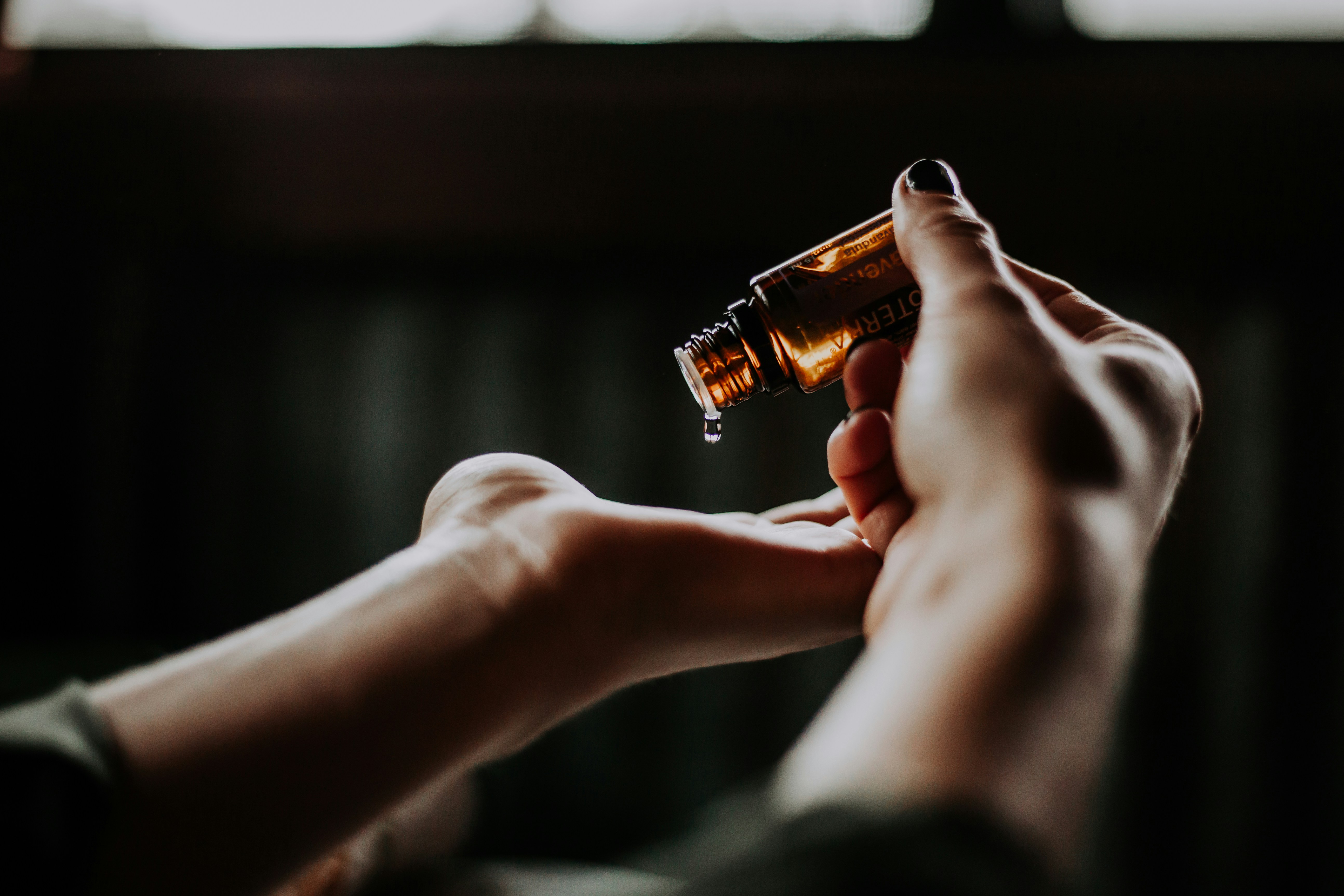 Aromatic essential oil poured into a hand